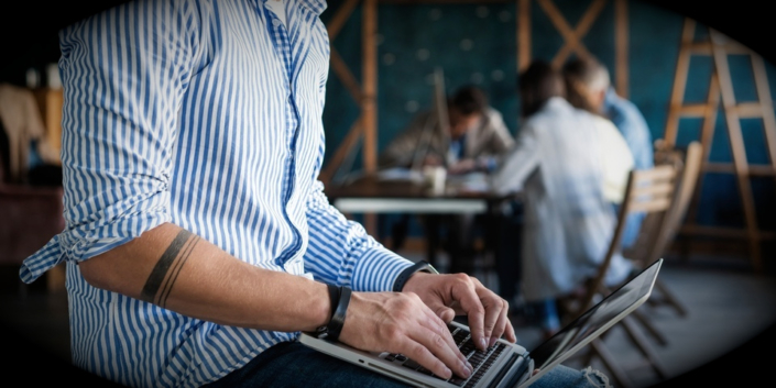 a contractor looking for a company car online on his laptop